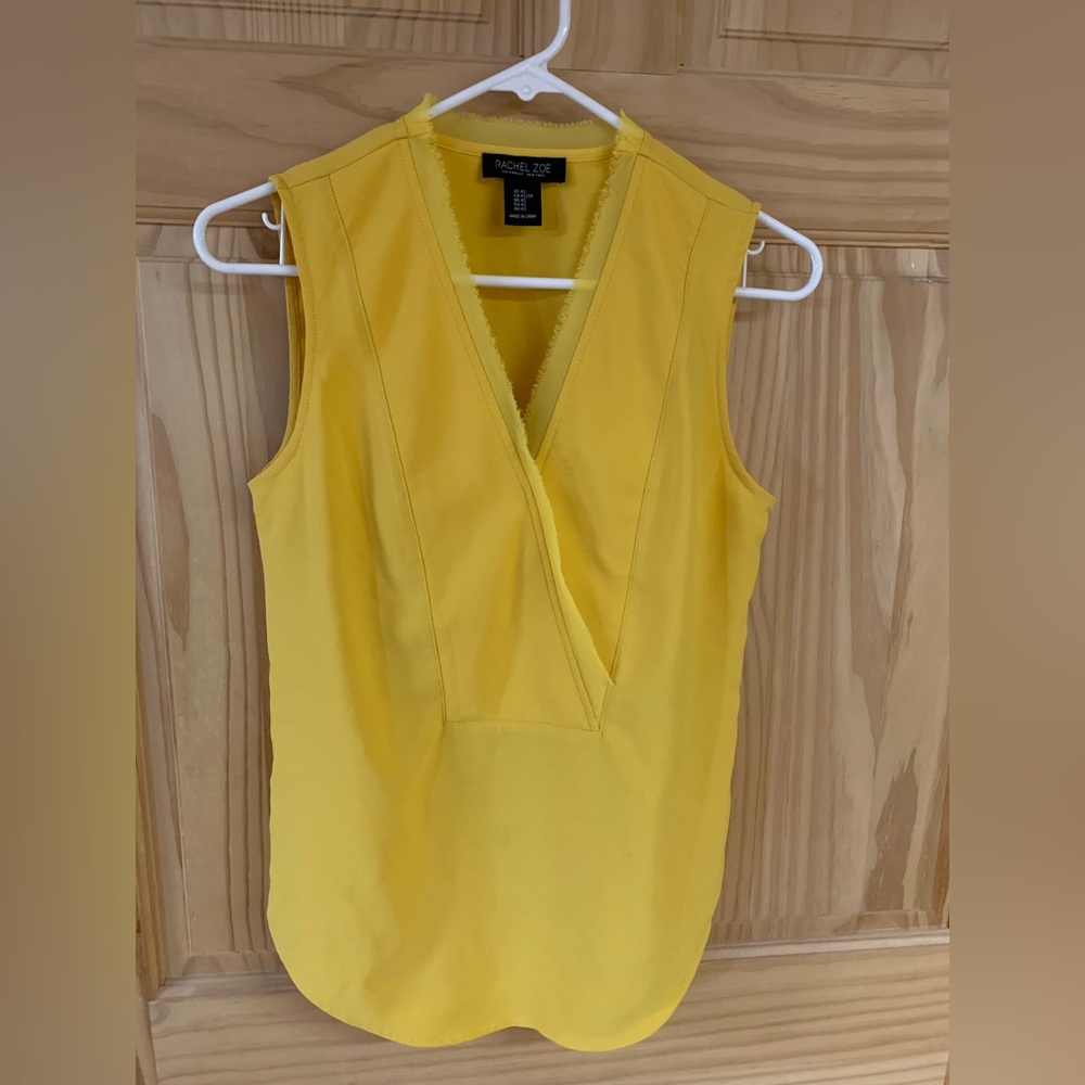 Woman’s yellow sleeveless blouse.